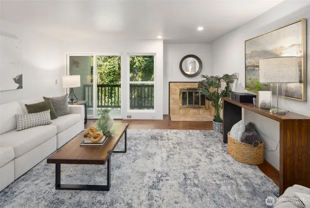 a living room with furniture a large window and a clock