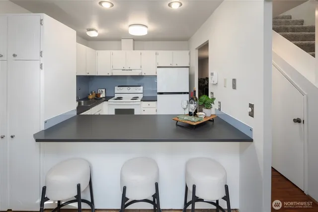a kitchen with cabinets a sink and appliances