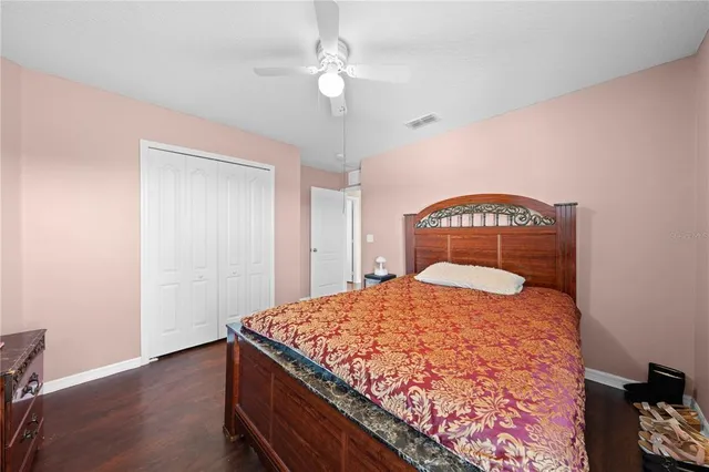 a bathroom with a granite countertop sink a toilet and a mirror