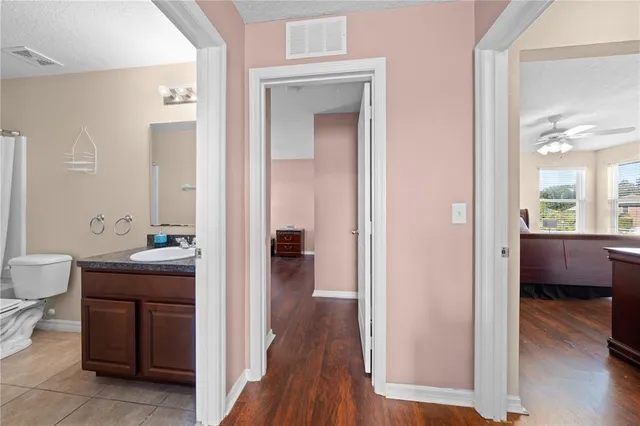 a white toilet sitting next to a white wall