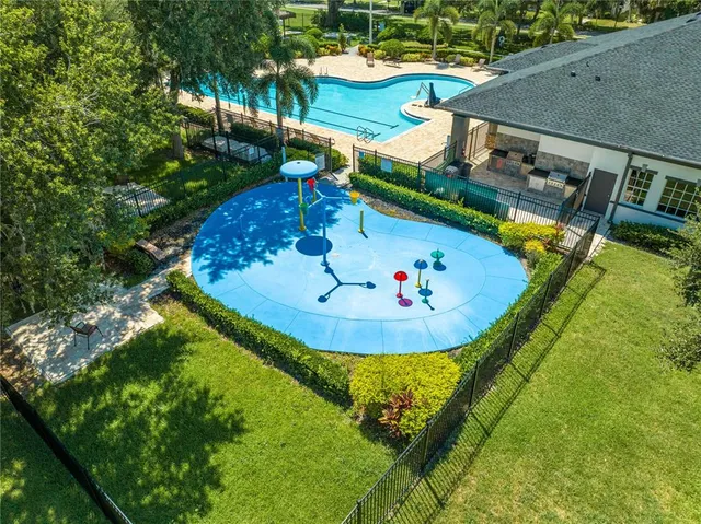 an aerial view of a house with a garden and swimming pool