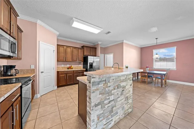 a kitchen with cabinets and chairs