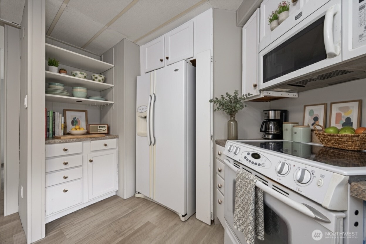 8532 Juniper Place Maple Falls, WA 98266 - Photo 11 of 37 a kitchen with white cabinets and white appliances