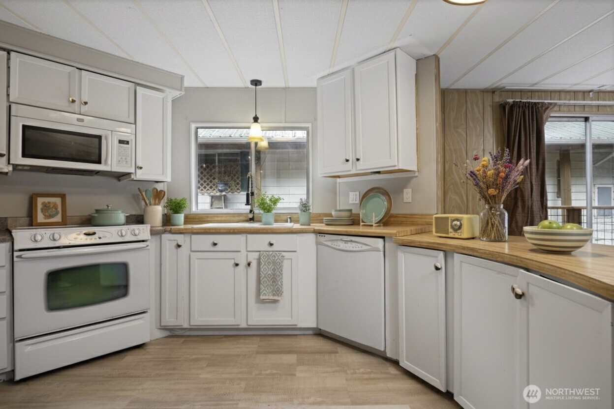 8532 Juniper Place Maple Falls, WA 98266 - Photo 13 of 37 a kitchen with white cabinets and white appliances