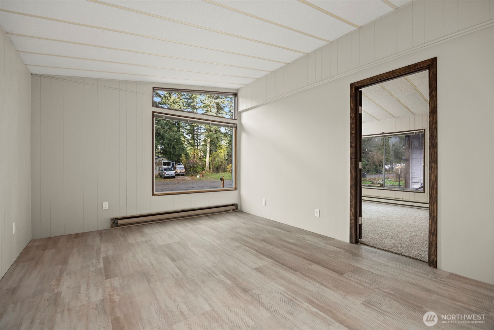 8532 Juniper Place Maple Falls, WA 98266 - Photo 6 of 37 a view of an empty room with wooden floor and a window