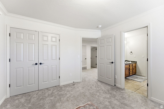 1712 Somerset Ridge Drive Draper, UT 84020 - Photo 47 of 76 Carpeted room featuring white paneled double doors with black hardware, white baseboards, and crown molding