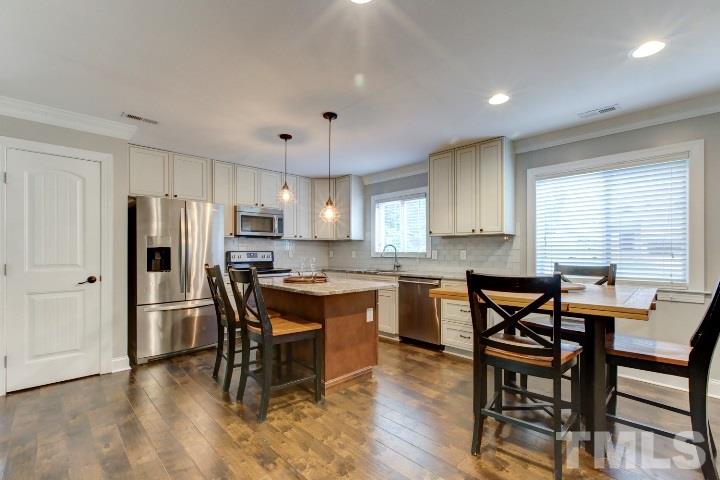 521 Ranch Farm Road Raleigh, NC 27603 - Photo 11 of 30 a view of a dining room with furniture and wooden floor