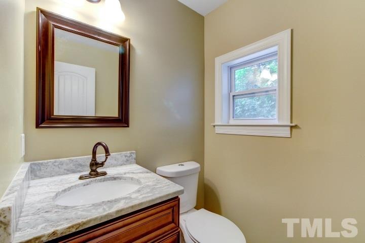 521 Ranch Farm Road Raleigh, NC 27603 - Photo 17 of 30 a bathroom with a toilet sink and mirror