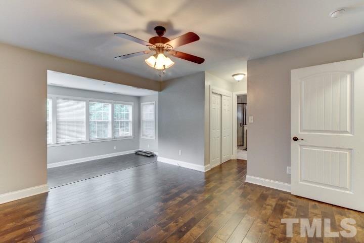 521 Ranch Farm Road Raleigh, NC 27603 - Photo 19 of 30 a view of an empty room with a window and wooden floor