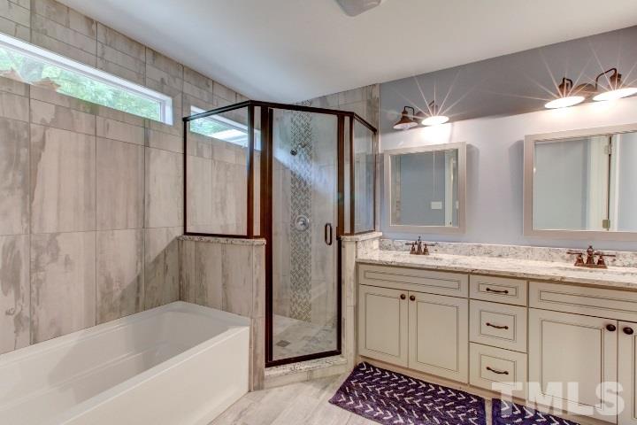 521 Ranch Farm Road Raleigh, NC 27603 - Photo 21 of 30 a bathroom with a double vanity sink mirror and bathtub