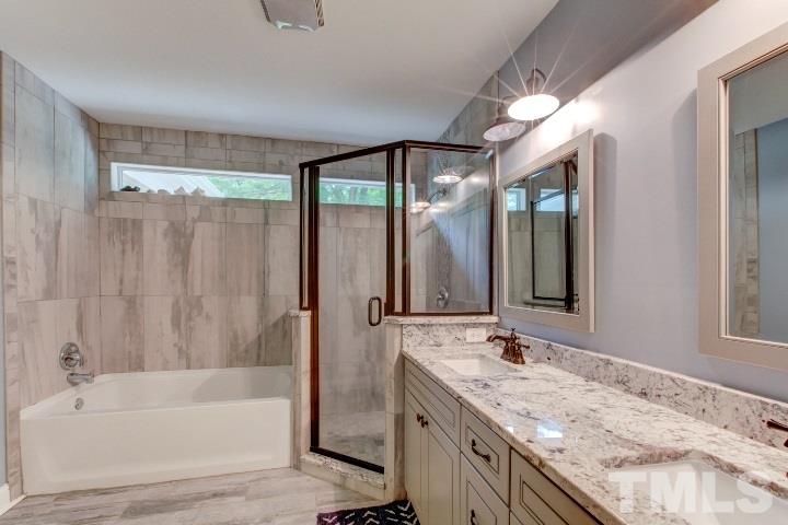 521 Ranch Farm Road Raleigh, NC 27603 - Photo 22 of 30 a bathroom with a granite countertop sink mirror bathtub and shower