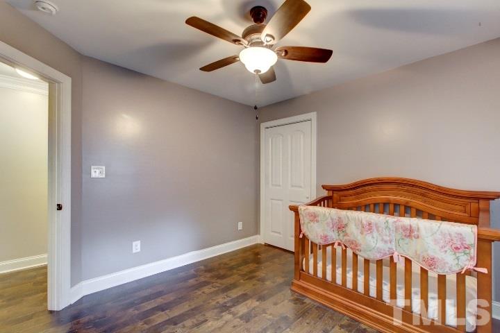 521 Ranch Farm Road Raleigh, NC 27603 - Photo 26 of 30 a bedroom with a bed and a ceiling fan