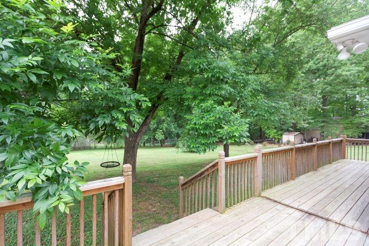 521 Ranch Farm Road Raleigh, NC 27603 - Photo 29 of 30 a view of a wooden deck and trees