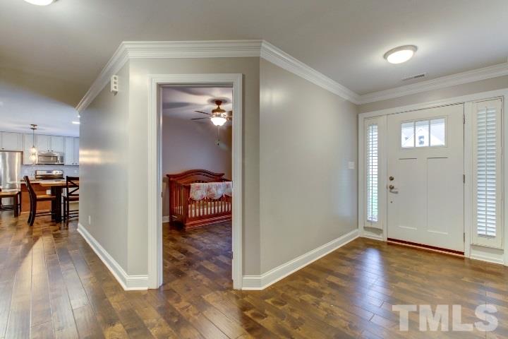 521 Ranch Farm Road Raleigh, NC 27603 - Photo 5 of 30 wooden floor in a hall with an entryway and a kitchen