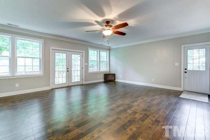 521 Ranch Farm Road Raleigh, NC 27603 - Photo 7 of 30 a view of an empty room with wooden floor and a window