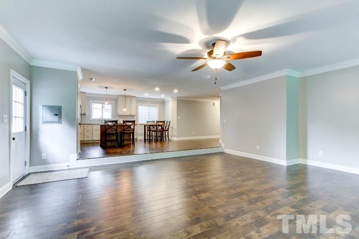 521 Ranch Farm Road Raleigh, NC 27603 - Photo 9 of 30 a view of a livingroom with furniture wooden floor a ceiling fan