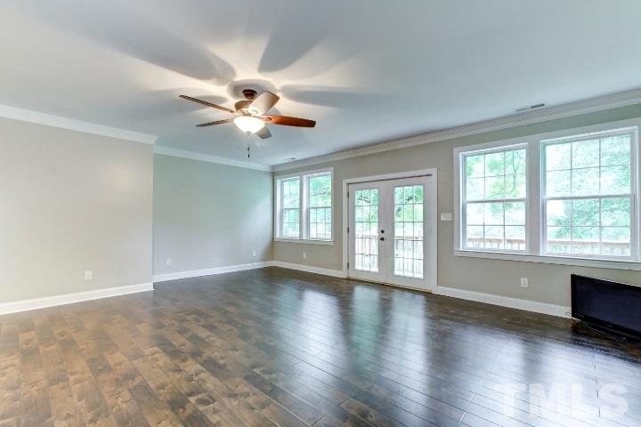 521 Ranch Farm Road Raleigh, NC 27603 - Photo 10 of 30 an empty room with wooden floor and windows