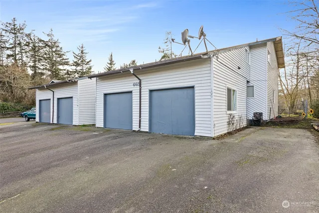 a view of a white house with a street