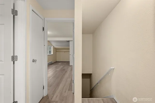 a view of a kitchen with wooden floor and electronic appliances