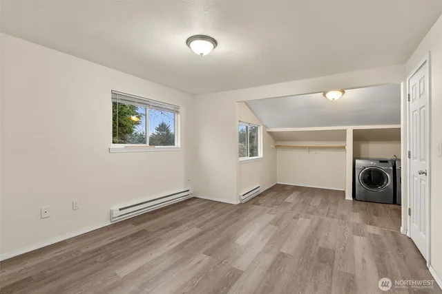 a kitchen with stainless steel appliances granite countertop a refrigerator a sink dishwasher a stove with wooden cabinets and floors