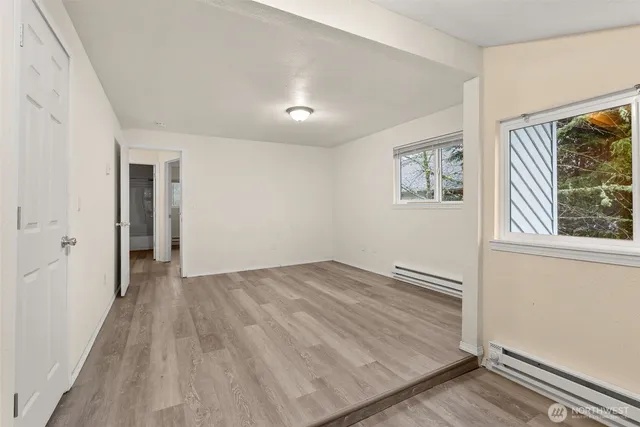 a kitchen with a refrigerator a stove top oven a sink and a window