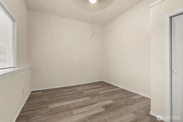 an empty room with windows and closet