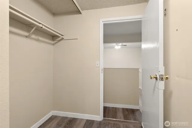 a view of a white house with a yard and sitting area