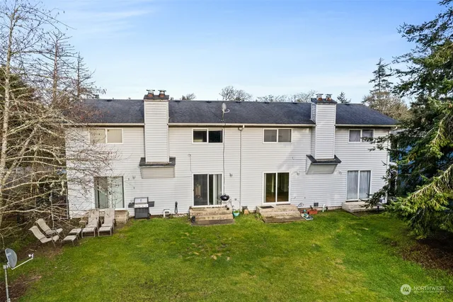 a view of a hallway with wooden floor and entryway