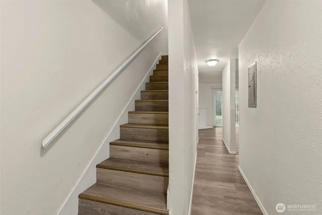 a view of an empty room with wooden floor