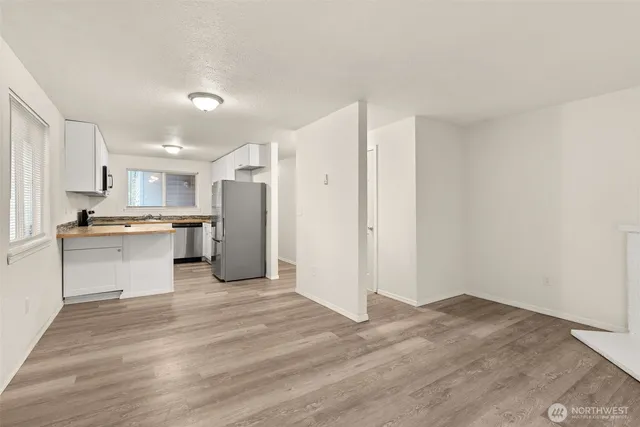a view of empty room with yard and floor to ceiling window