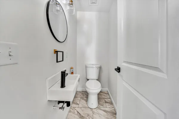 a bathroom with a toilet and a shower curtain