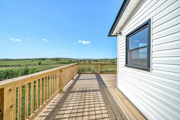 a view of balcony with wooden floor