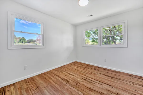a view of room with wooden floor and window