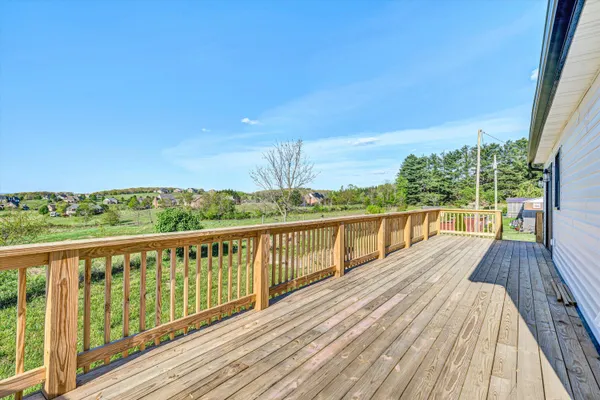 a view of balcony with wooden floor and fence
