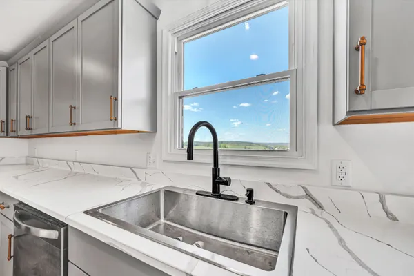 a kitchen with a sink cabinets and outdoor space