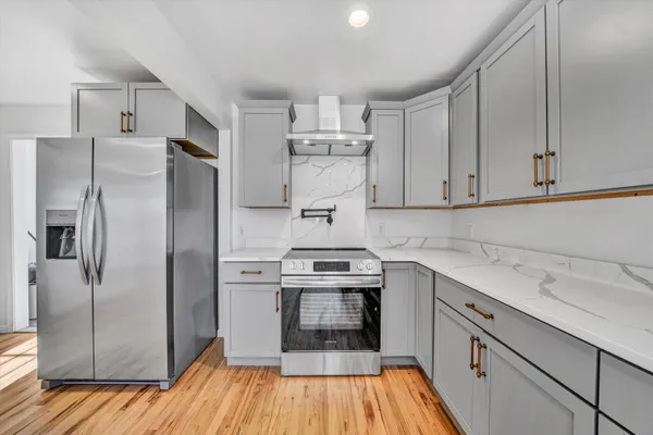 a kitchen with a sink stainless steel appliances and cabinets