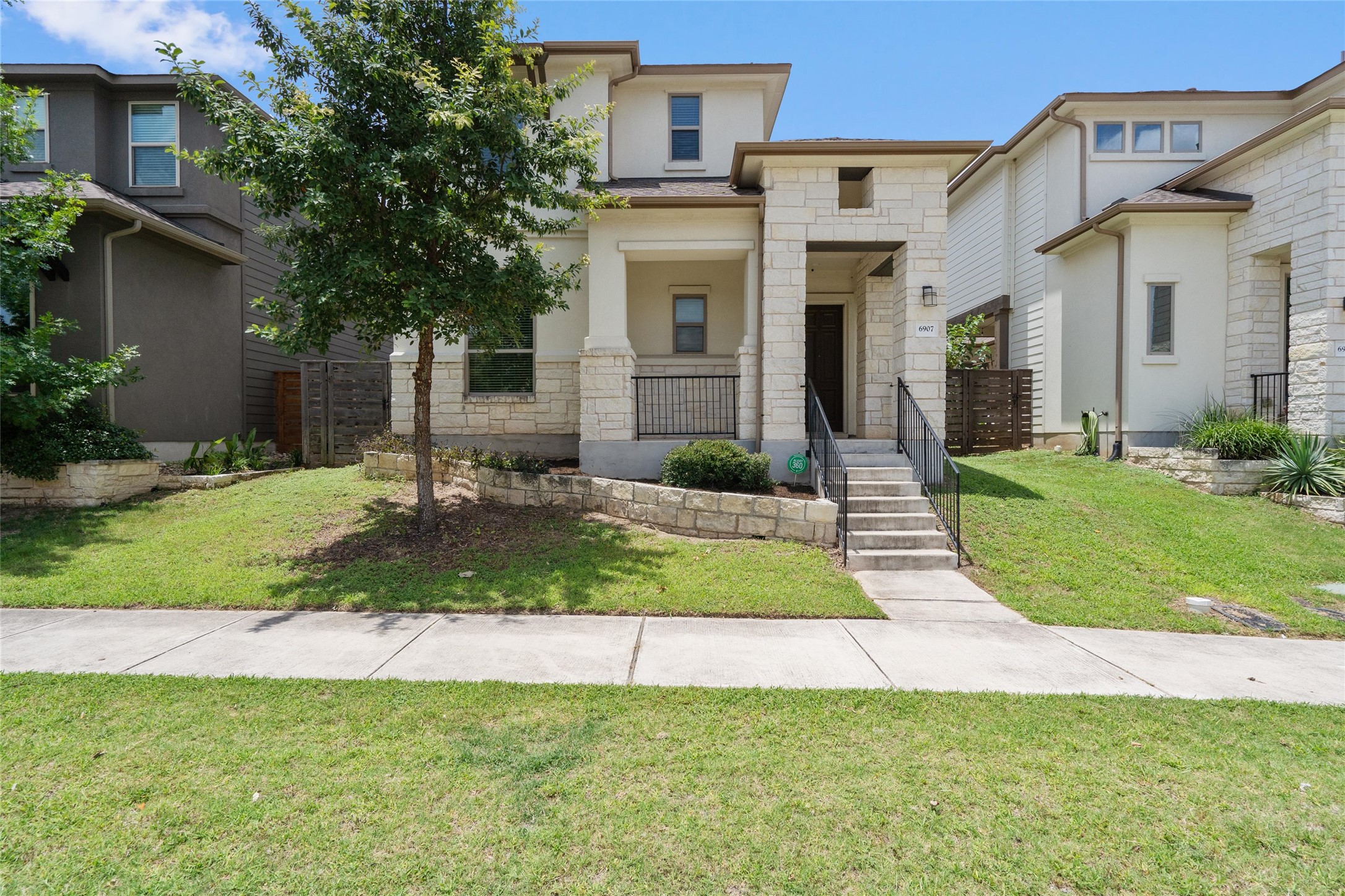 6907 Idea Road Austin, TX 78741 - Photo 1 of 36 a front view of a house with yard and green space