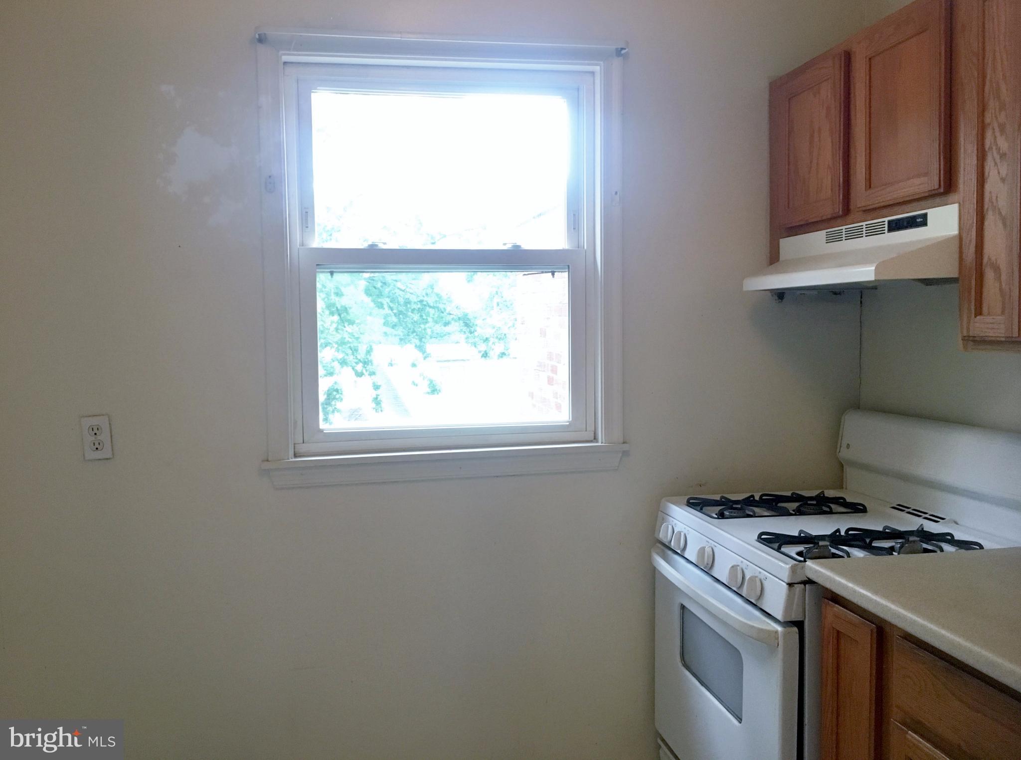 3714 Mayberry Avenue, Unit E Baltimore, MD 21206 - Photo 14 of 24 a kitchen with a stove and a window