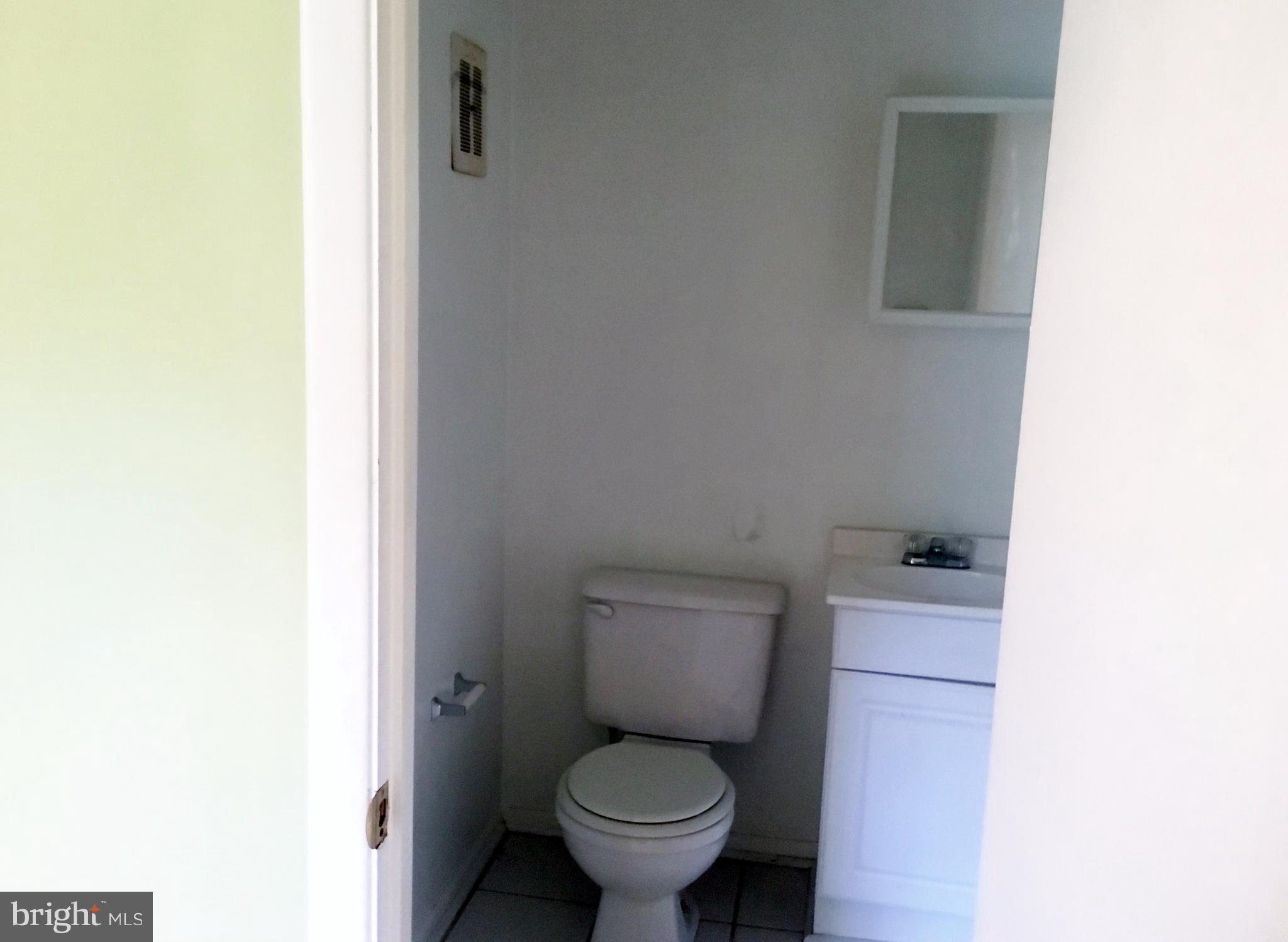 3714 Mayberry Avenue, Unit E Baltimore, MD 21206 - Photo 22 of 24 a white toilet sitting next to a white wall