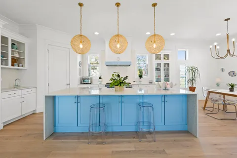 a view of a kitchen and a dishwasher a kitchen island with wooden floor