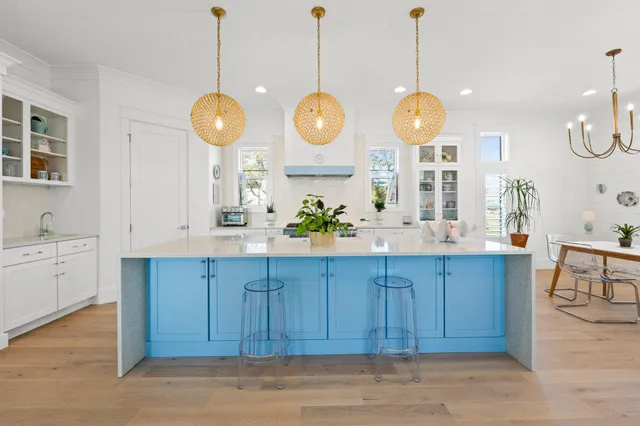 a view of a kitchen and a dishwasher a kitchen island with wooden floor
