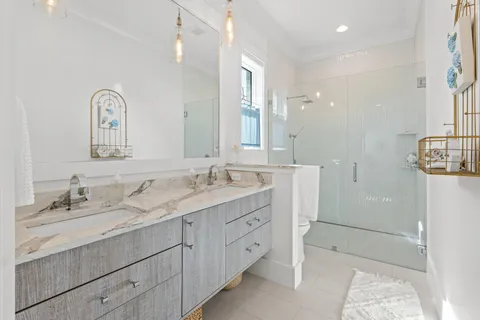 a bathroom with a double vanity sink and mirror