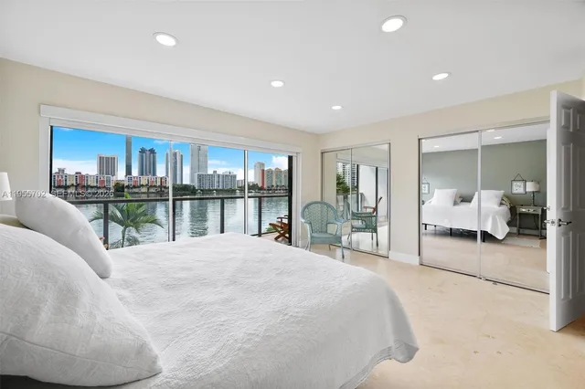 a large bedroom with a large bed and a large window