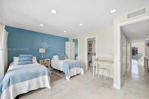 a spacious bedroom with two beds and painted walls