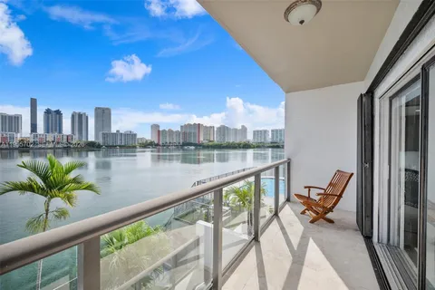 a view of swimming pool with outdoor seating and city view