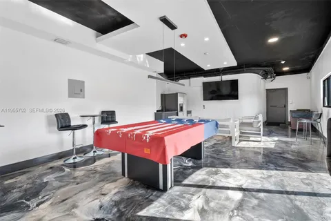 a spacious bedroom with a bed and a flat screen tv