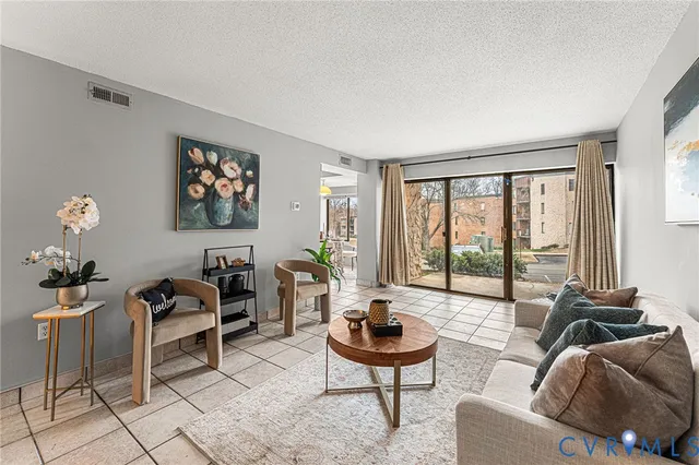 a living room with furniture and a floor to ceiling window