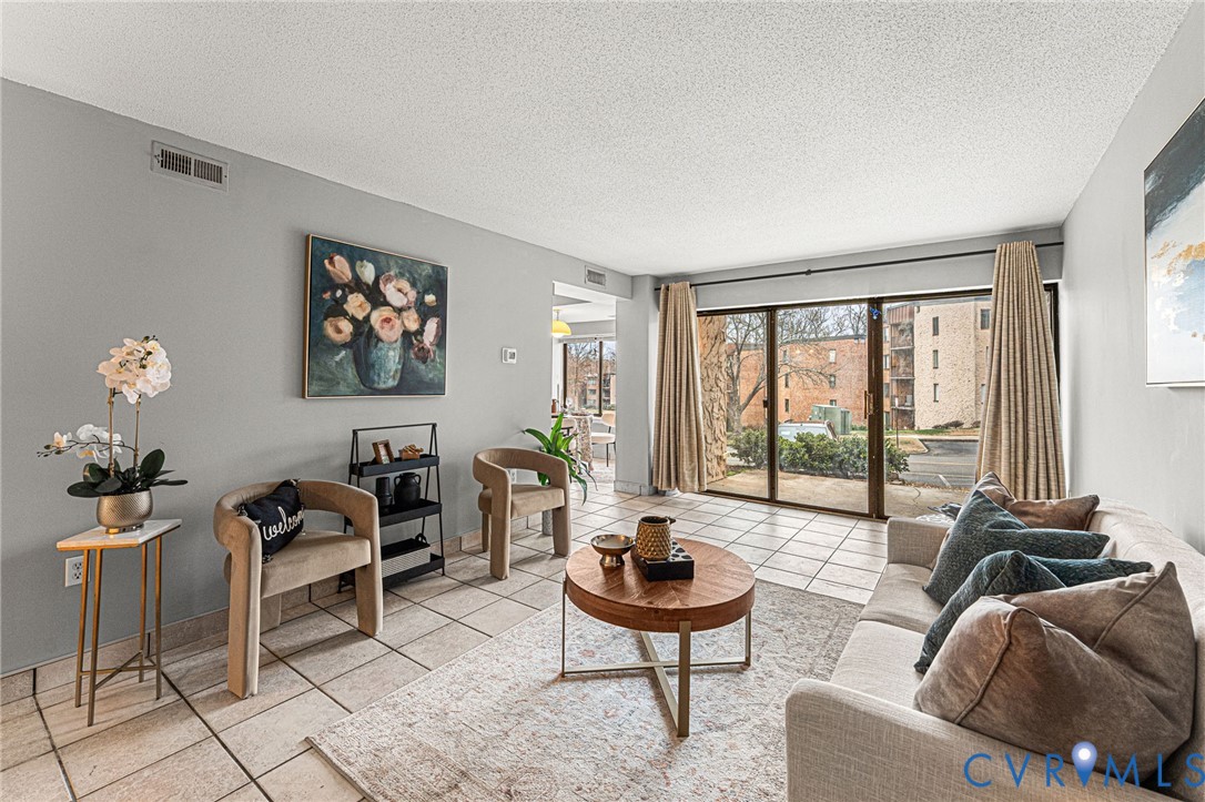 a living room with furniture and a floor to ceiling window