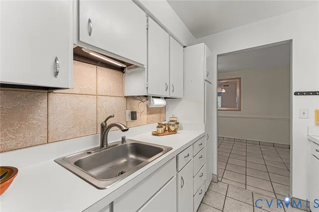 a kitchen with a sink a stove and cabinets