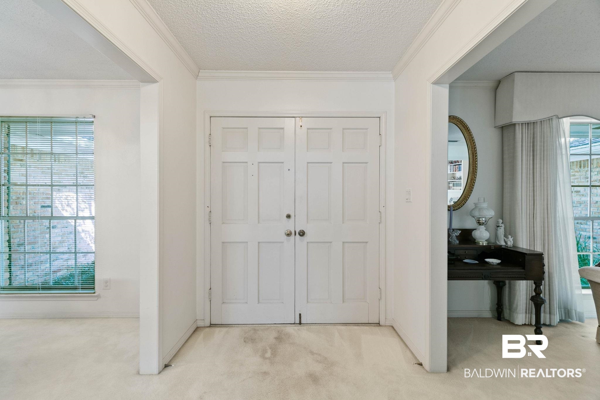 752 Evergreen Street Fairhope, AL 36532 - Photo 40 of 100 Foyer featuring a textured ceiling, ornamental molding, and carpet